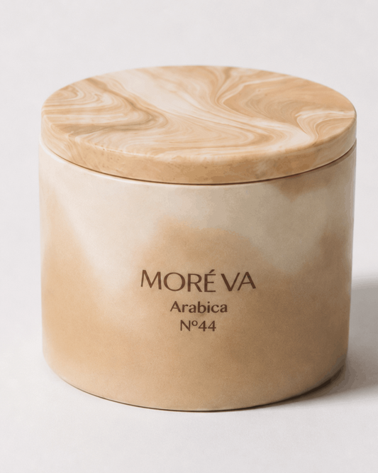a coffee scented candle in a brown jar with wooden lid