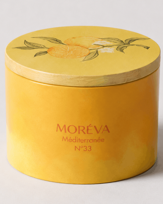 an orange and citrus candle in a jar with wax made out of soy with a wooden lid on top
